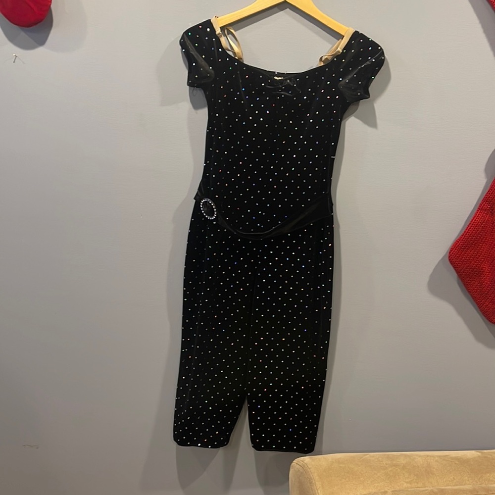 Black off the shoulder jumpsuit for dance or baton twirling. Belt is attached.